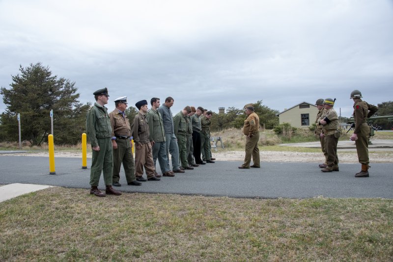 With the World War II tower as a backdrop, reenactors portray German submarine soldiers arrested during Fort Miles Defense Day.